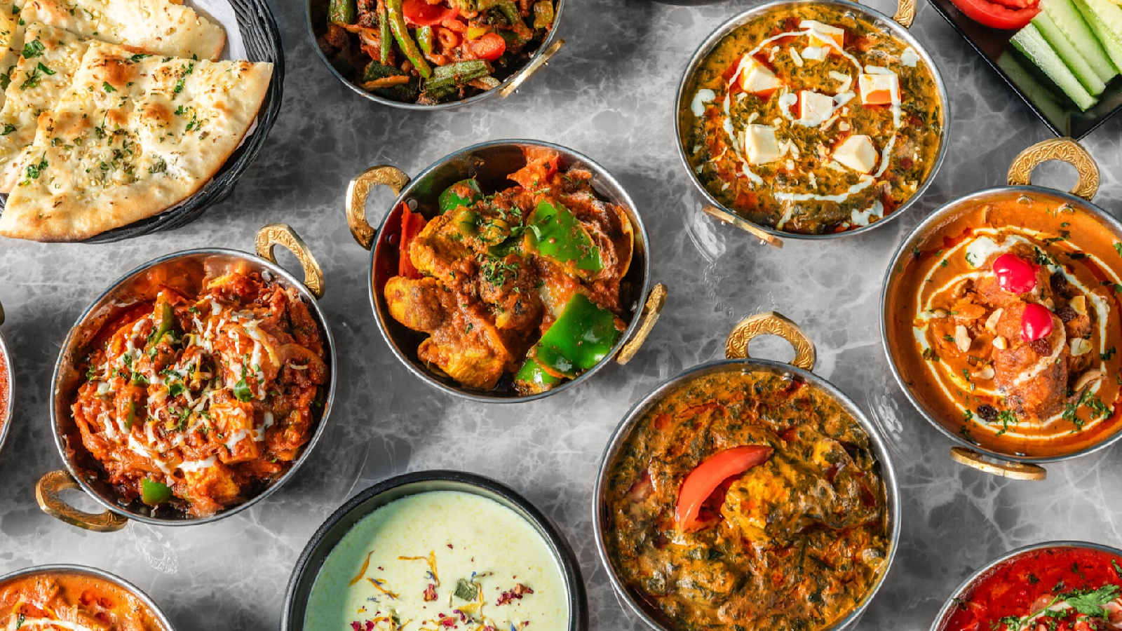 Curry's, dal en knoflooknaan van Indian Spot, geserveerd in koperen karahi's.